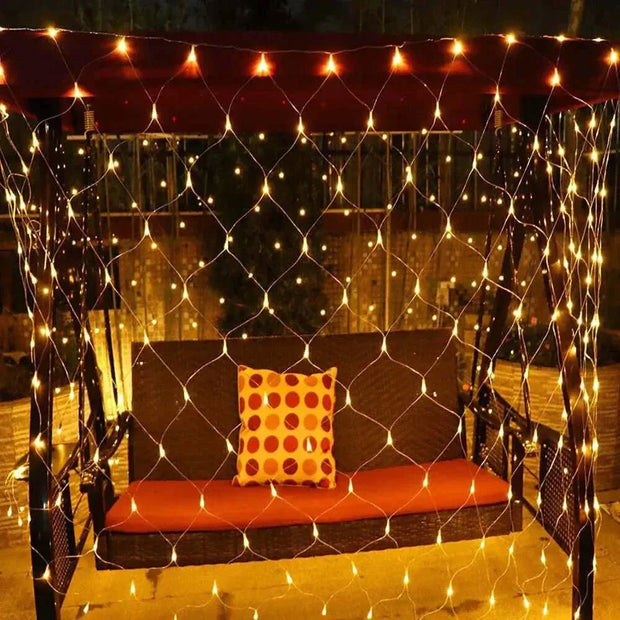 Net Mesh Solar Fairy Lights illuminating an outdoor seating area with warm white LED glow.