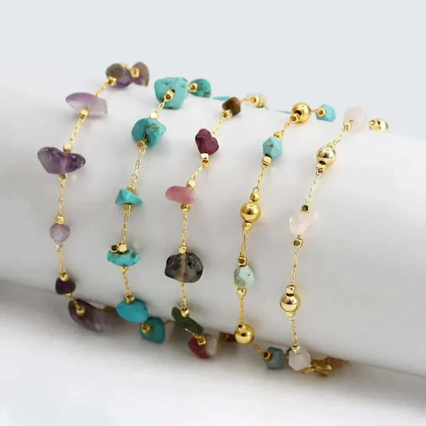Colorful charm bracelets with gemstones and gold accents, showcasing unique designs and versatility.
