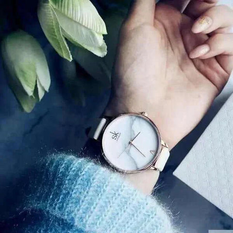Shengke Fashion Watch on wrist, modern design with white face and durable band.