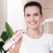 Woman using the Waterproof Irrigator Dental Cleaner for superior oral care at home.