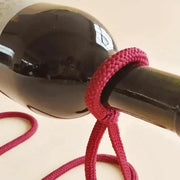 Suspended Rope Wine Bottle Holder with innovative design and durable rope securing a wine bottle.