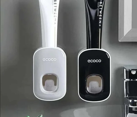 Automatic toothpaste dispenser with wall mount design in bathroom setting.