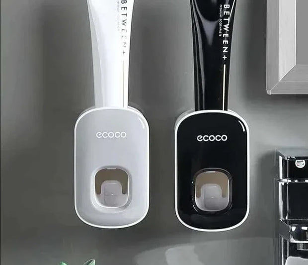 Automatic toothpaste dispenser with wall mount design in bathroom setting.