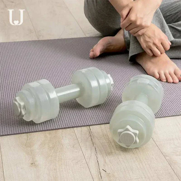 Fitness Water Barbell for home workouts, customizable resistance, ergonomic design on mat.