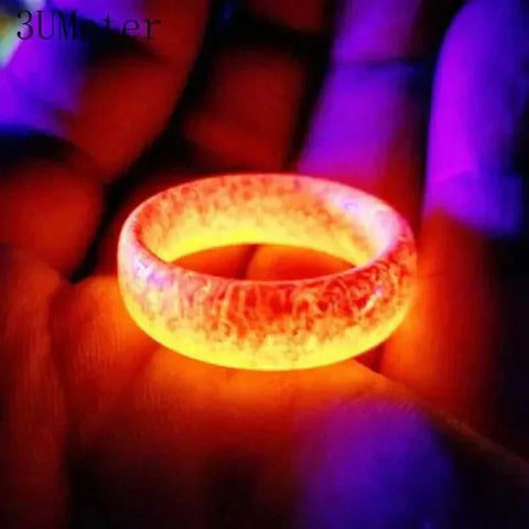 Unisex Luminous Ring glowing in the dark with vibrant colors.