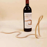 Suspended Rope Wine Bottle Holder featuring innovative design with durable cord, showcasing elegant wine display.