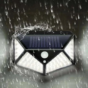 Outdoor waterproof garden solar lamp with LED lights in rain.