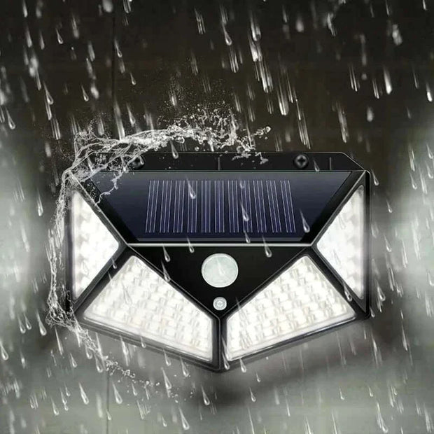 Outdoor waterproof garden solar lamp with LED lights in rain.