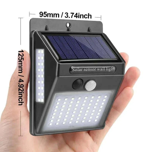 Compact Garden Solar Lamp with LED lights and solar panel in hand, dimensions 95mm x 125mm.