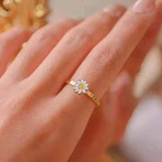 Fidget Spinner Ring with daisy design on finger, stylish and functional accessory.