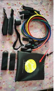 Fitness resistance bands set with handles, door anchor, and carrying pouch on a patterned surface.
