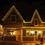 Net Mesh Solar Fairy Lights illuminating a house exterior at night, enhancing festive decor.
