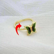 Fidget Spinner Ring with butterfly design on white fabric background.