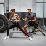 People exercising with fitness resistance bands in a gym setting.