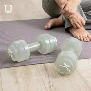 Fitness Water Barbell for home workouts on a yoga mat, offering customizable water resistance.