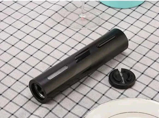 Automatic Wine Bottle Opener with sleek design and foil cutter, on a checkered tablecloth.