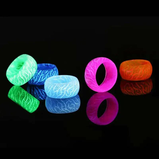 Colorful Love Glow Rings displaying vibrant luminescence on a reflective surface.