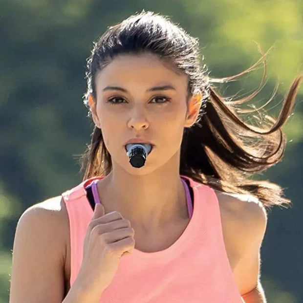 Woman using Lung Fitness Trainer while jogging outdoors.