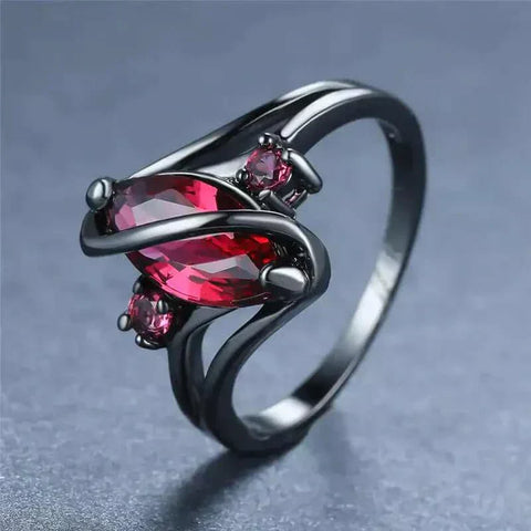 Elegant Crystal Ring with a dazzling red crystal centerpiece and intricate design.