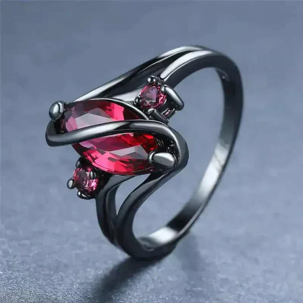 Elegant Crystal Ring with a dazzling red crystal centerpiece and intricate design.