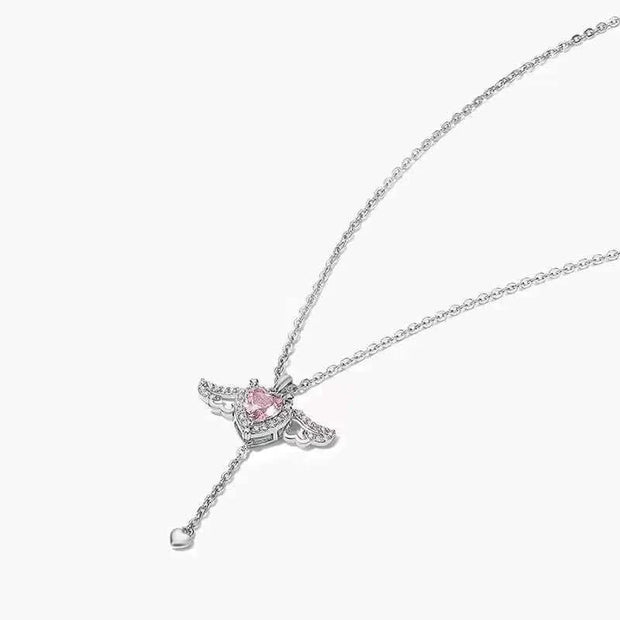 Heart Wings Necklace with delicate heart and wings design, silver chain, and pink gemstone centerpiece.