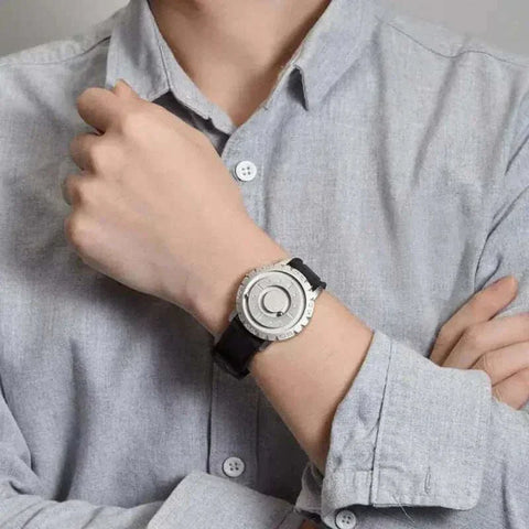 Magnetic Pointer Watch on wrist with sleek black dial and rubber strap.