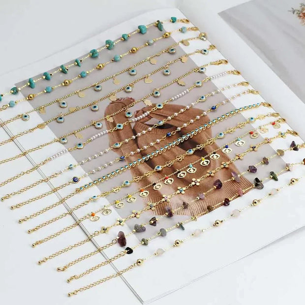 Elegant charm bracelets with colorful beads and gold accents displayed on a magazine.