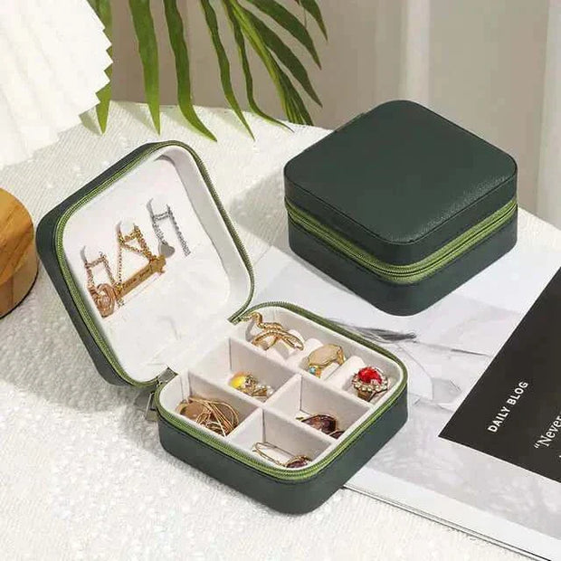 Jewelry zipper box storage with compartments for necklaces, bracelets, earrings, and rings.
