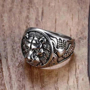 Vintage Lion Head Ring in stainless steel with intricate design on wood background.