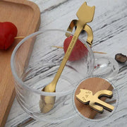 Stainless steel cat-shaped teaspoons with adorable handles in a glass cup.