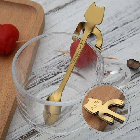 Stainless steel cat-shaped teaspoons with adorable handles in a glass cup.