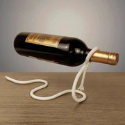 Suspended Rope Wine Bottle Holder displaying bottle with elegant design on wooden surface.